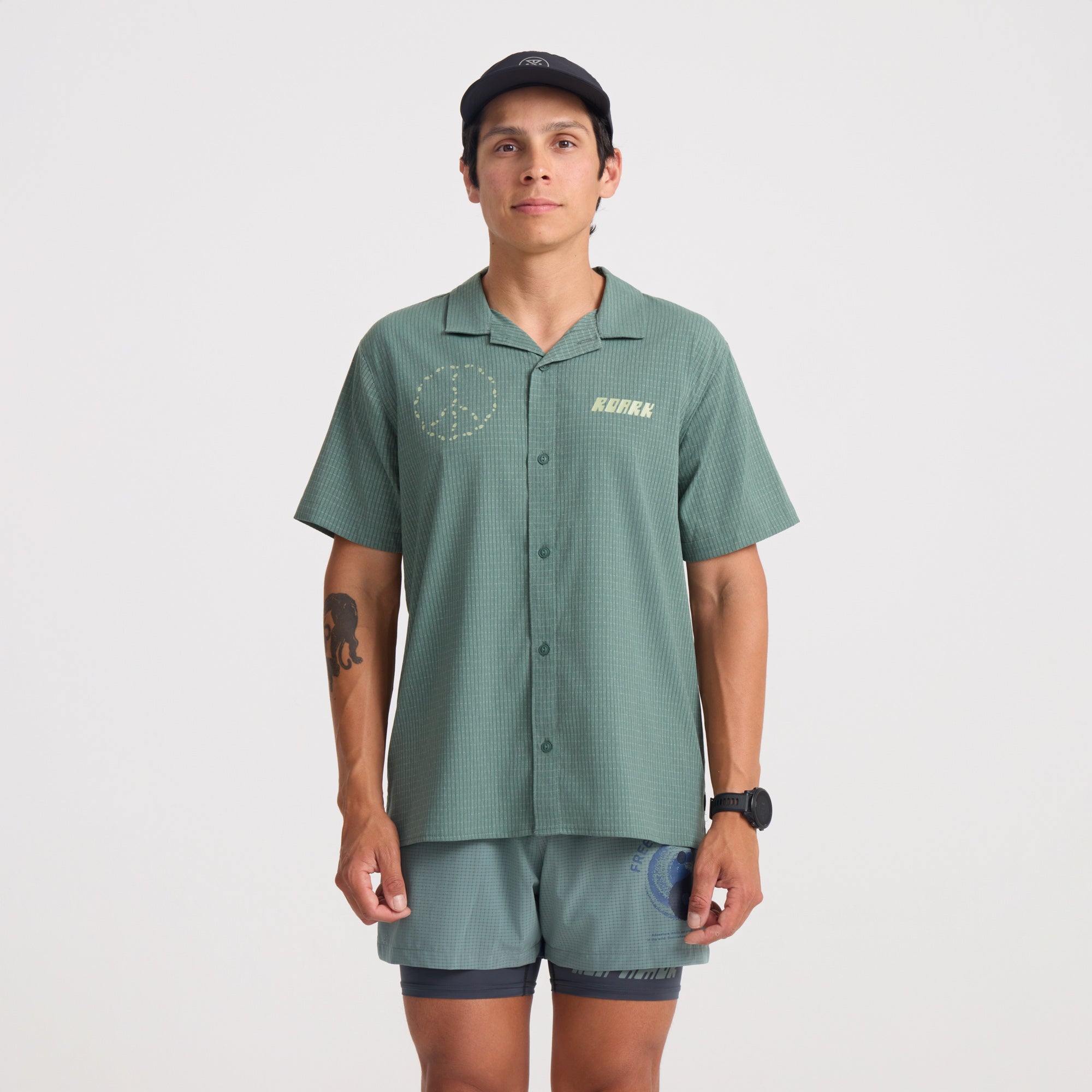 Active shirt surrounded by tropical fruits, embodying the adventure and travel spirit of Roark.