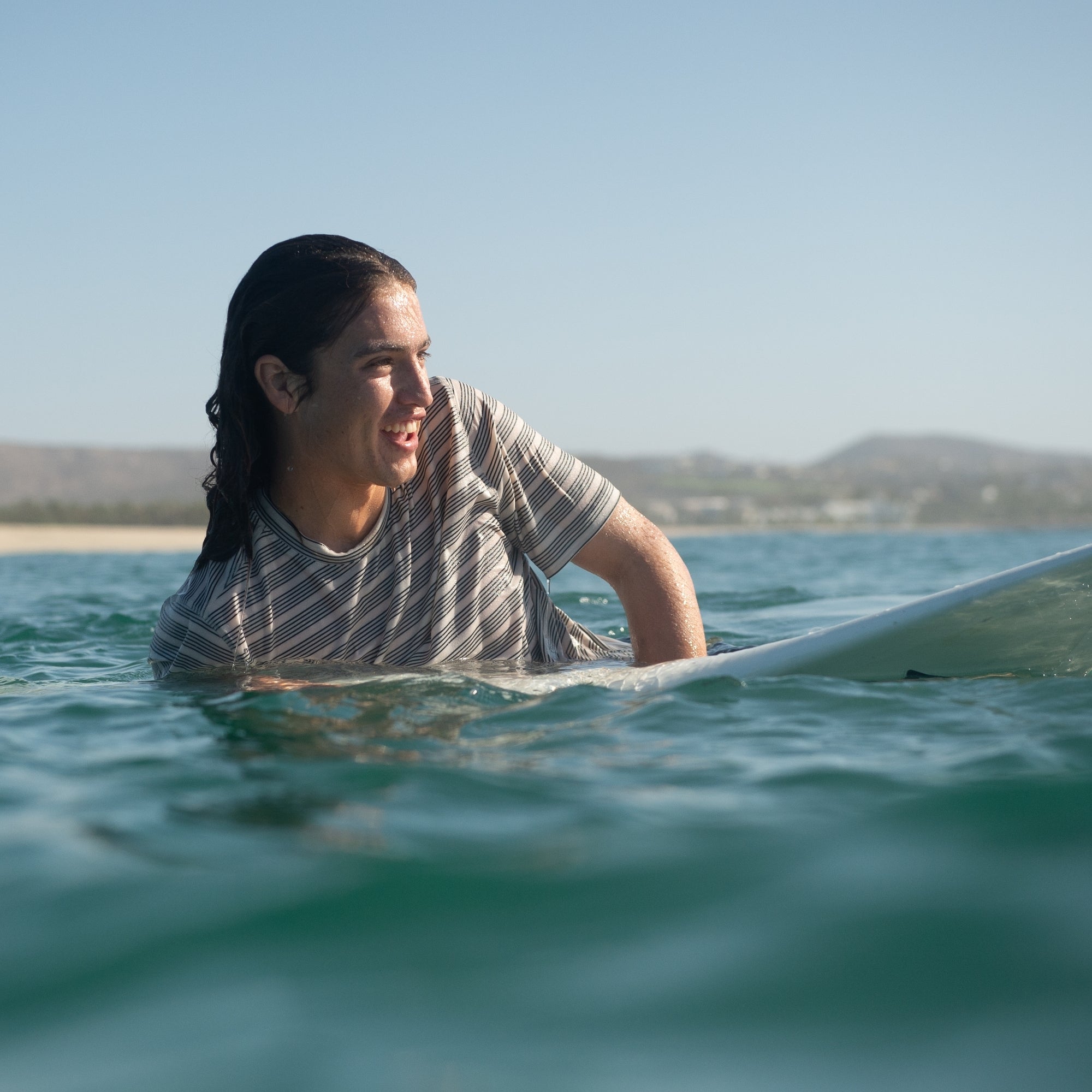 Surfbrett und Surfausrüstung an einem sommerlichen Strand, die die Essenz von Abenteuer und Wassersport einfangen